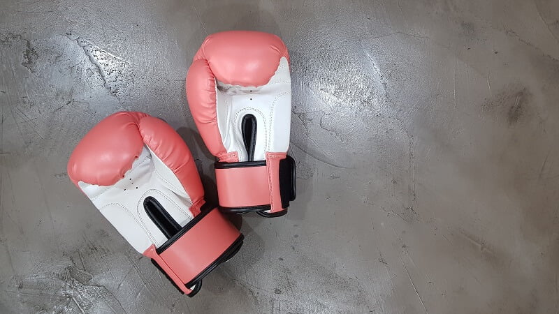 pink boxing gloves on a concrete floor.jpg